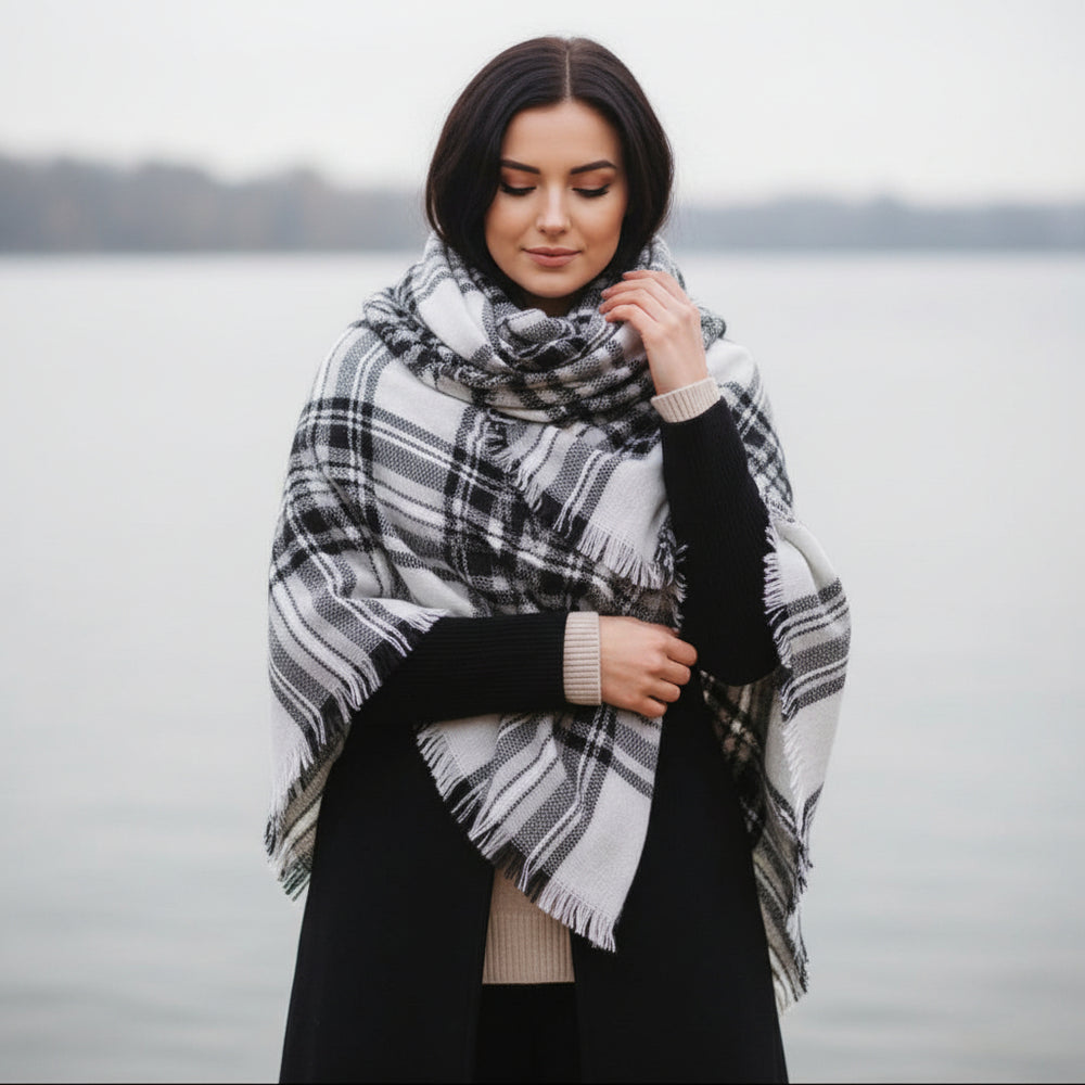 Woman wearing a plaid scarf in a forest during autumn